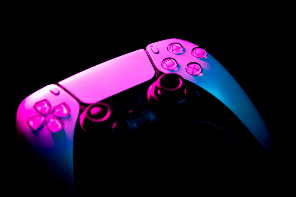 Cinematic console gaming scene glowing in emerald and teal